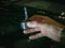 A xenon light bulb in the man\'s hand. A professional worker changes the new xenon lamps of the car