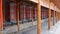 XIAHE, CHINA - AUGUST 24, 2018: People pass a row of praying wheels around Labrang Monastery in Xiahe town, Gansu