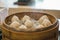 Xiao Long Pao in small bamboo steaming basket.