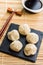 Xiaolongbao, traditional steamed dumplings and soy sauce. Xiao Long Bao buns on cutting board