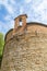 XIII century baptistery church with brick wall and small bell