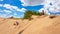 Xilinhot - A man in shorts sitting on a sand dune on Hunshandake Desert in the nearby of Xilinhot, Inner Mongolia