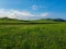 Xilinhot - A panoramic view on a hilly landscape of Xilinhot in Inner Mongolia. Endless grassland with a few wildflowers between