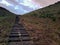 Xilinhot - A staircase leading to the top of a small hill in the suburbs of Inner Mongolia. The hills are overgrown with grass