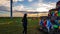 Xilinhot - A woman in beanie walking around a heap of stones Aobao build on a vast pasture in Xilinhot in Inner Mongolia