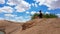 Xilinhot - A woman in shorts sitting on a sand dune on Hunshandake Desert in the nearby of Xilinhot, Inner Mongolia.