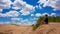 Xilinhot - A woman in shorts sitting on a sand dune on Hunshandake Desert in the nearby of Xilinhot, Inner Mongolia.