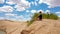 Xilinhot - A woman in shorts sitting on a sand dune on Hunshandake Desert in the nearby of Xilinhot, Inner Mongolia.