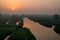 XINGHUA, CHINA: Canal in rapeseed field at morning