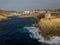 Xlendi Tower and Xlendi Bay rocky coastline aerial Gozo island after the storm