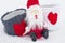 Xmas concept. Santa Claus sits on the snow with two love mugs. C