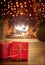 Xmas at home. Red gift boxes, blur burning fireplace background