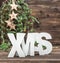 XMAS letter and christmas ornaments over wooden background