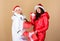 Xmas present box. winter holidays. family vacation. women in down jacket. girls santa claus hat. christmas fashion. warm