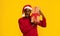 Xmas Present. Surprised Black Guy In Santa Hat Holding Christmas Gift Box