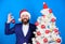 Xmas shop. merry christmas. bearded man santa hat hold xmas ball. magic creativity. white christmas. businessman