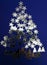 Xmas tree in a fantasy of fir trees, stars sky and snow