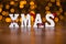 Xmas white decorated text standing over holidays lights background