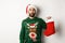 Xmas and winter holidays concept. Happy man got a gift in Christmas sock, looking excited, standing in Santa hat against