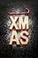 \'Xmas\' wooden letters, sugar as snow and red candy canes on black