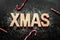 \'Xmas\' wooden letters, sugar as snow and red candy canes on black