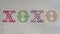 XOXO cross stitched on white