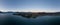 XXL panoramic evening sunset high angle aerial drone view of the town of Wanaka, a popular ski and summer resort town