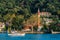 Yacht in the Bosphorus Strait against the background of houses on the shore. Boat trip along the Golden horn Bay