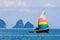 Yacht with colourful multi coloured sails
