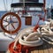 Yacht deck with lifebuoy sail, ropes and wheel. AI generative.