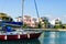 Yacht entering marina with houses on the background