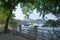 Yacht, fishing and recreational boats on lake, fence and mountains