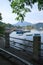 Yacht, fishing and recreational boats on lake, fence and mountains