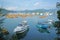 Yacht, fishing and recreational boats on lake and mountains