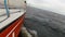 Yacht floats by the storming sea