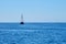 Yacht with lowered sails at sea in sunny weather