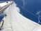 Yacht mast with the sail on the blue sky, Dominican Republic