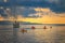 Yacht in the mediterranean sea at sunrise, Cagliari, Italy. People sail on kayaks on the open sea under the sun. The sun