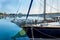 Yacht moored in the harbor of a quiet fishing town in a sunny, clear day.