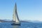 Yacht is moving along the coast. Sailing yacht in blue sea. Nature.