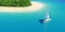 Yacht near tropical sand beach with palms.