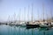 Yacht parking in harbor, harbor yacht club in Agios Nikolaos, Crete, Greece. Beautiful Yachts in blue sky background
