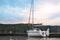 Yacht in the port on Lake Solina in the Bieszczady Mountains (Poland) illuminated by the gently setting sun.