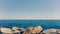 Yacht with sail in the blue sea near the horizon