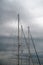 Yacht sail masts foggy sky at background