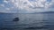 Yacht or sailboat moored in the seashore. Sea wave. Huge clouds in the dramatic sky.