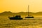 Yacht and sailboat silhouette at golden sunset