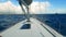 Yacht sailing at sea. The ocean shown from the sailboat`s front