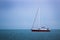 Yacht sailing at waves of the sea. Nautical landscape with sailboat - cruising yacht sailing under full sail taking part in regatt