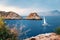 Yacht sails at Mediterranean sea between cliffs, Mallorca
